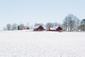 Old red farm houses in the winter wonderland Royalty Free Stock Photo