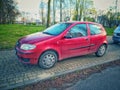 Old red Fiat Punto two doors parked