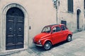 Old red Fiat 500 R to stand near a wall