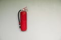 An old red fire extinguisher hangs on the wall of a house, ready for emergency fire accidents Royalty Free Stock Photo