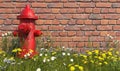 An old red fire hydrant stands in the grass with wildflowers opposite a brick wall. Front view. Illustration with copy space. 3D r