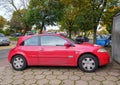 Old red French car Renault Megane II DCi parked near autumn trees Royalty Free Stock Photo