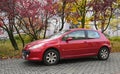 Old red small French family compact car 3-door hatchback body Peugeot 307 Royalty Free Stock Photo