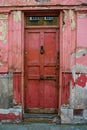 Old red front door with peeling paint Royalty Free Stock Photo