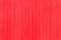 Old, red grunge wood vertical panels on a rustic barn Royalty Free Stock Photo