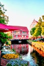 Old red half-timbered house and colorful flowers in Wismar at the canal. Baltic Sea in Mecklenburg-Vorpommern. Germany