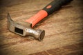 Old red hammer on wood background Royalty Free Stock Photo