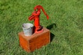 Old red hand powered pump Royalty Free Stock Photo