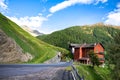 Old red house on Timmeljoch mountain pass on Italian side of Alps on the way to Merano, South Tyrol, Italy. Royalty Free Stock Photo