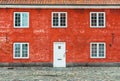 Old red house with white windows and door Royalty Free Stock Photo