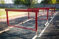 Old red hurdles for a hurdle race on abandoned stadium Royalty Free Stock Photo