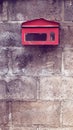 Old red mailbox on concrete wall. Royalty Free Stock Photo