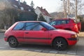 Old red Mazda 323 parked