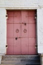 Old red metal door with white brick wall in Kolomenskoye park, M Royalty Free Stock Photo