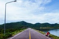 Old red motorcycle park by lake with summer sky and mountain Royalty Free Stock Photo