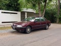 Old red 1995 Peugeot 405 SRI saloon, sedan in the street. Sunny day. Classic car. Royalty Free Stock Photo