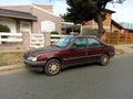 Old red 1995 Peugeot 405 SRI saloon, sedan in the street. Sunny day. Classic car Royalty Free Stock Photo