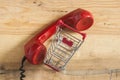 Red old fashioned telephone receiver on wooden table Royalty Free Stock Photo