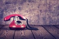 Old red phone on the wooden table Royalty Free Stock Photo