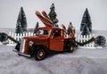 Old red pickup truck with giant candy canes