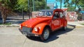 old red Citroen IES 3CV America 1986 parked in the street. Trees in th background. Classic car show