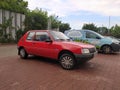 Old red popular French car supermini Peugeot 205 Junior parked Royalty Free Stock Photo