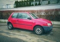 Old small red simple popular veteran compact car Volkswagen Lupo parked Royalty Free Stock Photo