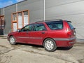 Old red Renault Laguna 2.0 hatchback parked.