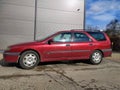 Old red Renault Laguna 2.0 hatchback parked.