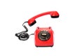 Old, red rotary dial telephone with hanging in the air receiver, isolated on white Royalty Free Stock Photo