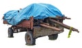 Old red rural tractor trailer cart wuith wooden logs and blue  tarpaulin plastic  cover isolated on white Royalty Free Stock Photo