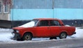 Old red rusty car with snow on the hood Royalty Free Stock Photo