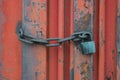 Old red container door with a lock on a chain Royalty Free Stock Photo
