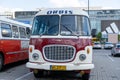 The old red Skoda bus rides through the streets of the Polish capital. Tourist bus vintage model. The street of the old