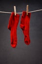 Old red socks hanging on rope Royalty Free Stock Photo