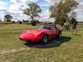 Old red sport 1970s Corvette C3 Stingray convertible roadster in the countryside. Classic muscle car Royalty Free Stock Photo