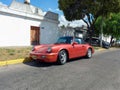 Old red sport car 1990s Porsche 911 Carrera 2 Type 964 cabriolet turbo look speedster in the street Royalty Free Stock Photo