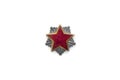 Old red star from military cap isolated on the white background