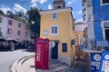 Old red telephone booth on the street in Lisbon Royalty Free Stock Photo