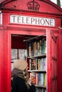 Old red telephone booth used as a library in Lewisham. London, 2017.
