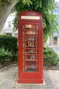 Old red telephone box with a door, a bookcase with books for the population, a tourist, historical concept, architecture of