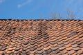 Old red tile roof against a blue sky Royalty Free Stock Photo