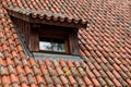 Old red-tiled rooftop with a window in German village, idyllic rural scene Royalty Free Stock Photo