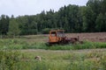 An old red tracked tractor stands abandoned Royalty Free Stock Photo