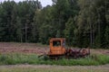 An old red tracked tractor stands abandoned Royalty Free Stock Photo