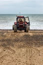 Old red tractor on a beach Royalty Free Stock Photo