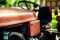 An old red tractor on a farm field. Royalty Free Stock Photo