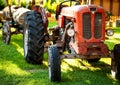 An old red tractor on a farm field. Royalty Free Stock Photo