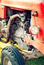 An old red tractor on a farm field. Royalty Free Stock Photo