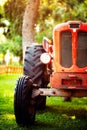 An old red tractor on a farm field. Royalty Free Stock Photo